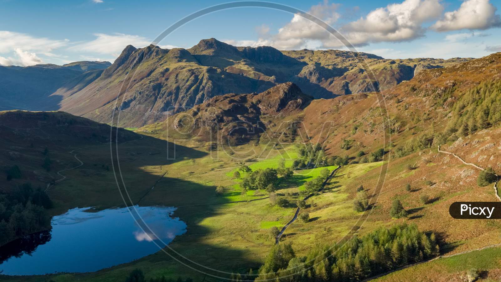 Blea Tarn Aerial Passover Which Shows The Tarn And Surrounding Area Including, Side Pike And Harrison Stickle, Thorn Crag, Blea Rigg And The Langdale Fells, In The English Lake District.Uk