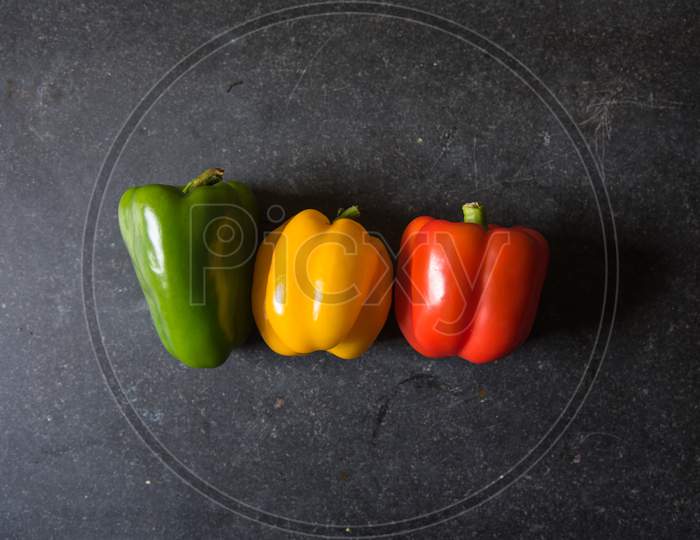 Top view of red yellow and green bell peppers