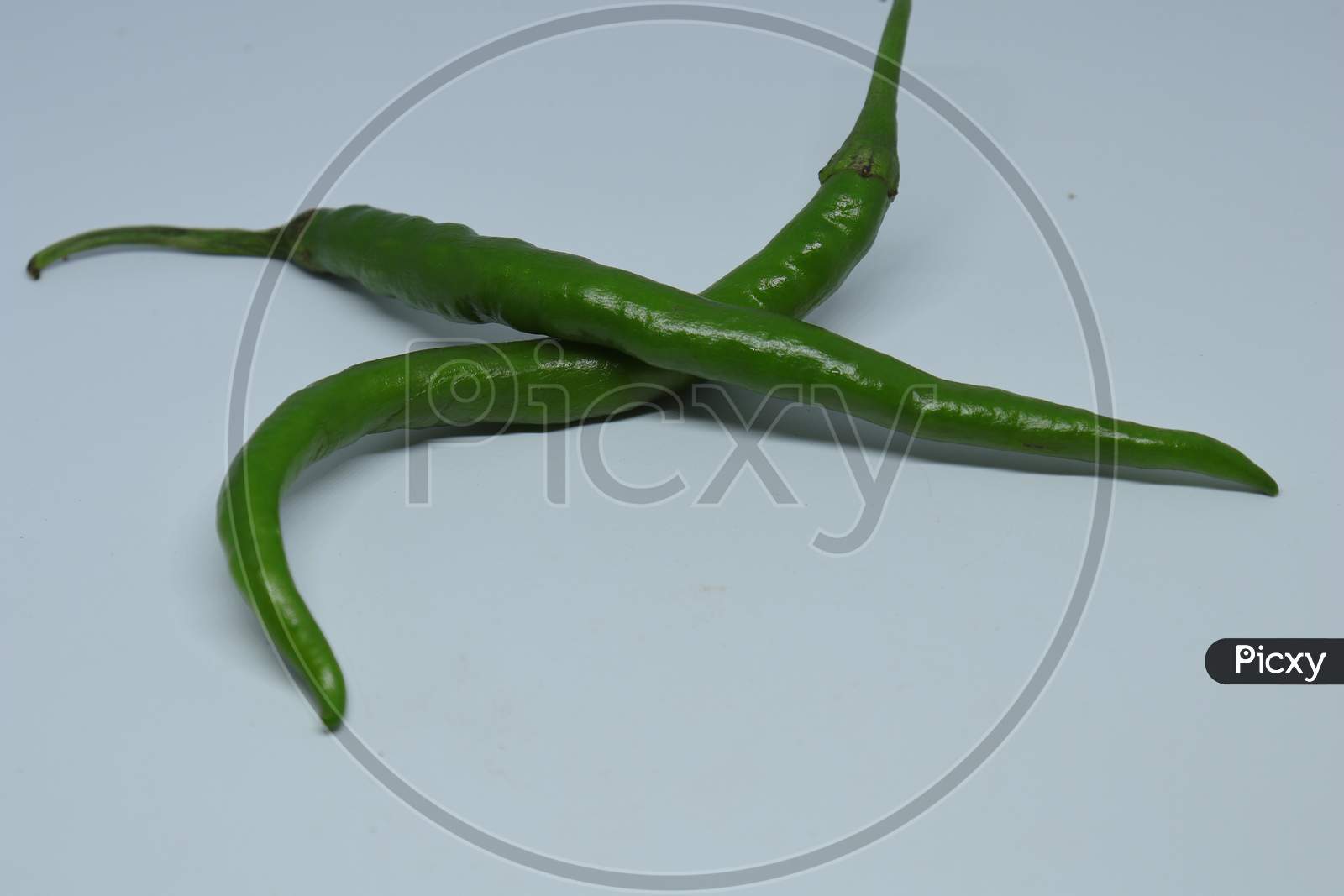 green cayenne pepper with a white background