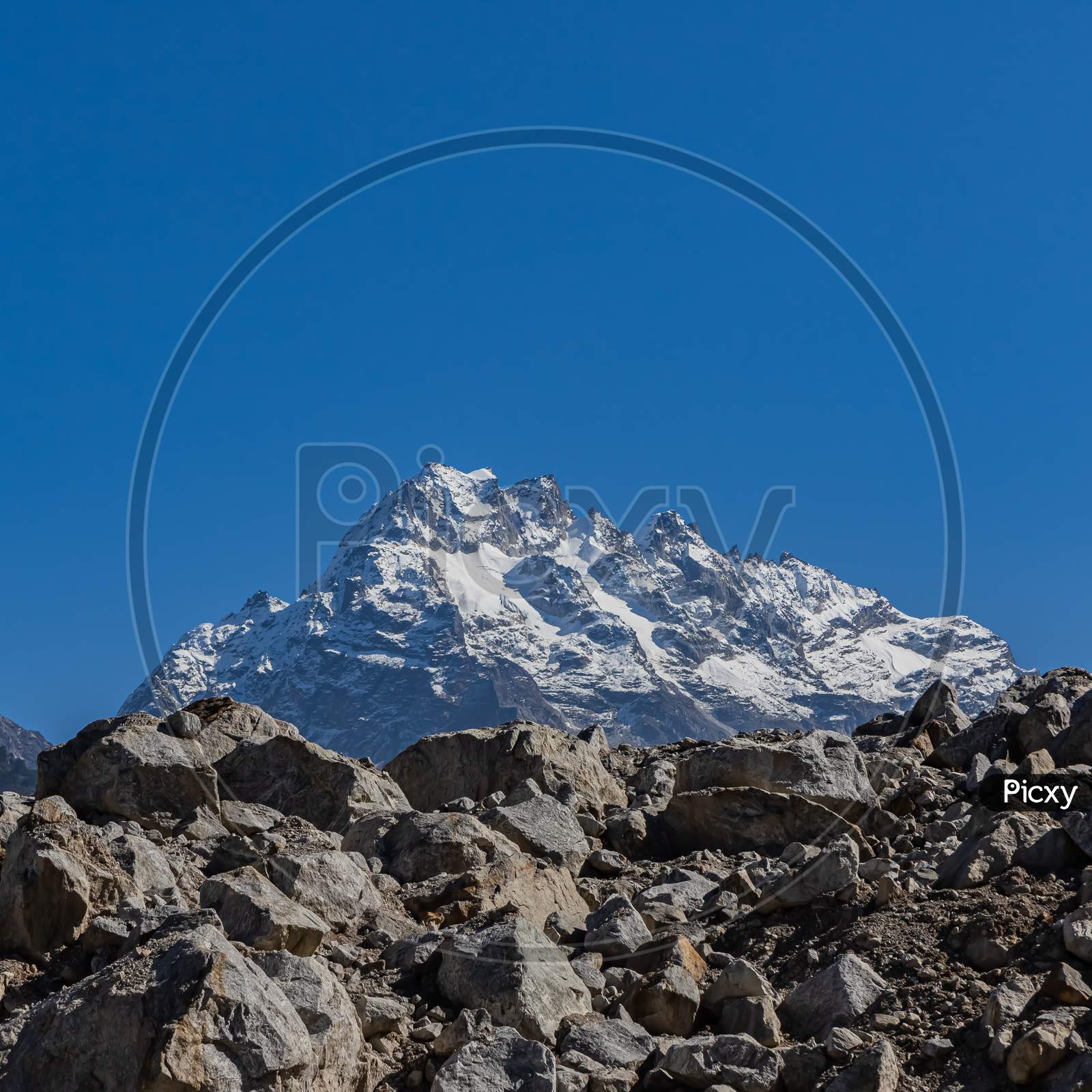 A postcard image of a majestic peak with blue sky on the horizon