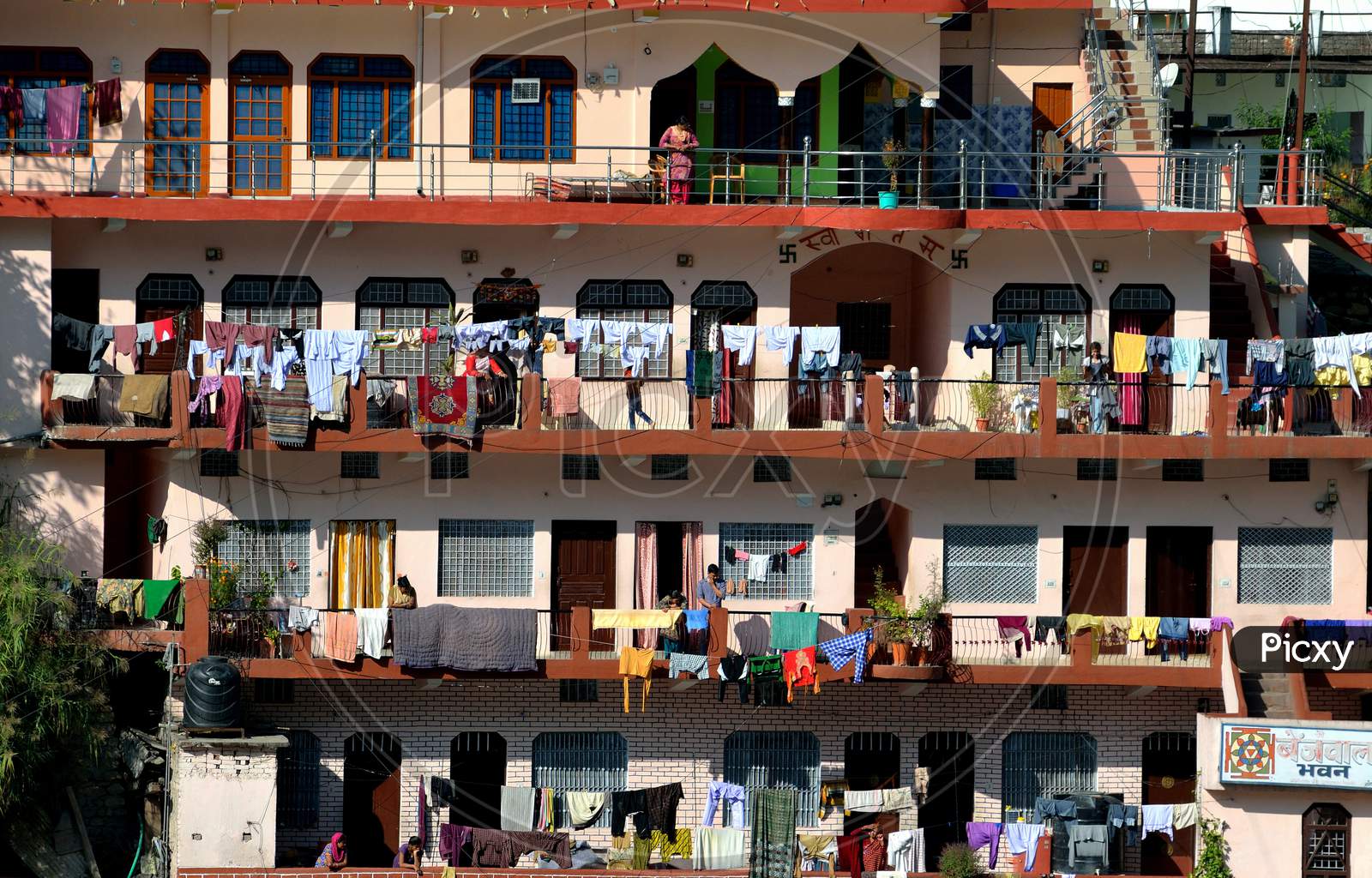 Different Floors of a building with the drying clothes along the balcony