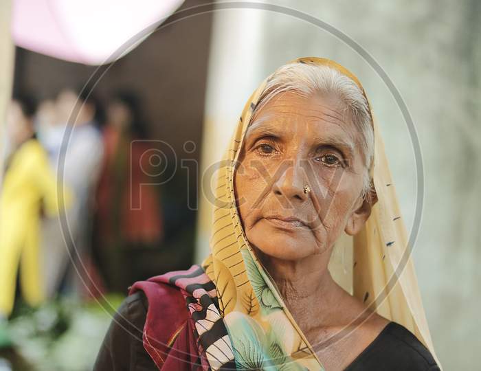 Ahemdabad, Gujarat, India - 20Th June, 2019: Old Indian Village Woman Wearing Saree Looks At The Camera With No Expressions On Her Face.