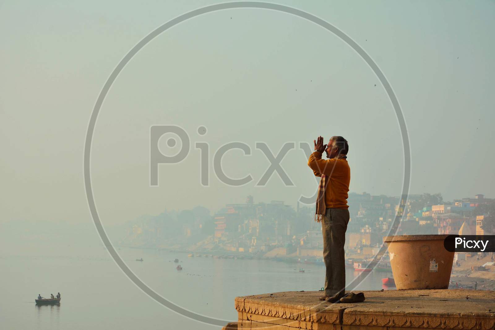 A devotee doing  Surya Namaskar on the bank of Ganges in Benras