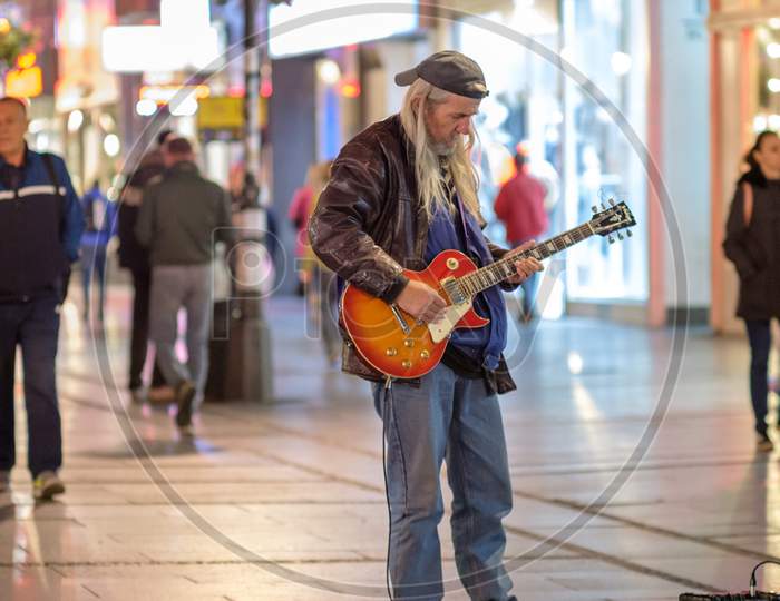 Old Rocker Playing An Electric Guitar In Knez Mihailo Street In Belgrade, Serbia