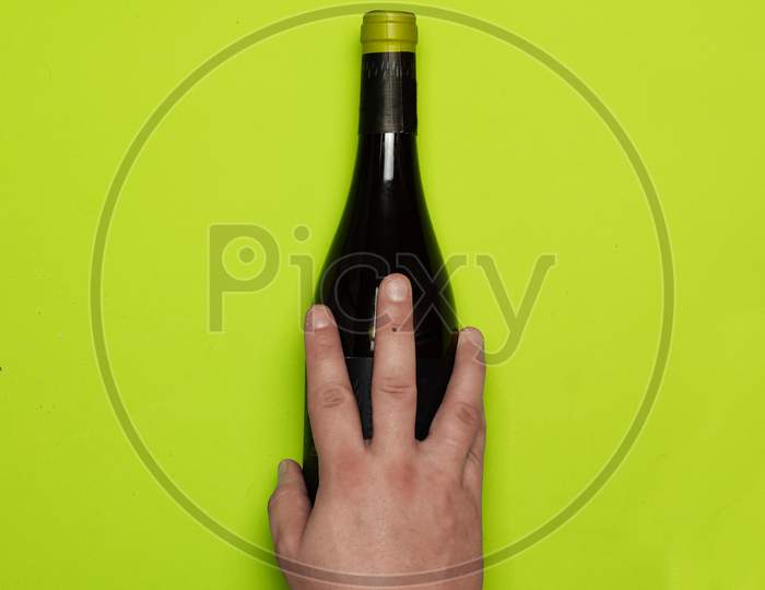 Top View Of Man'S Hand Over Wine Bottle. Flat Lay