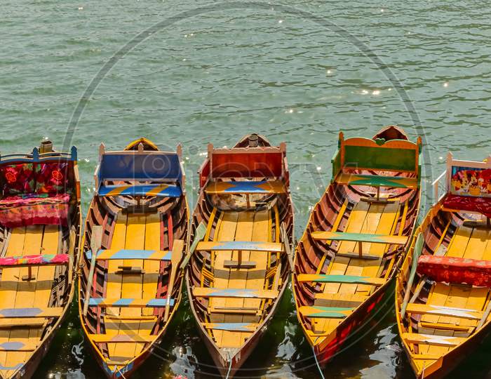 Boats floating on water in a lake in hill station Bhimtal in Nainital district