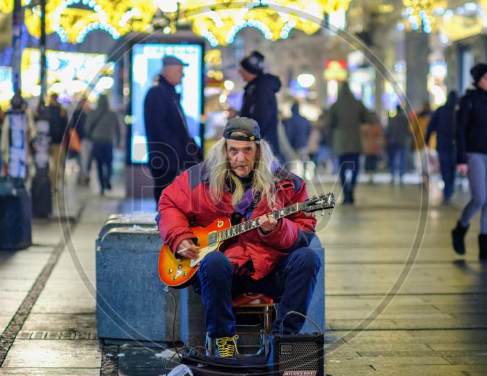 Old Rocker Playing An Electric Guitar In Knez Mihailo Street In Belgrade, Serbia