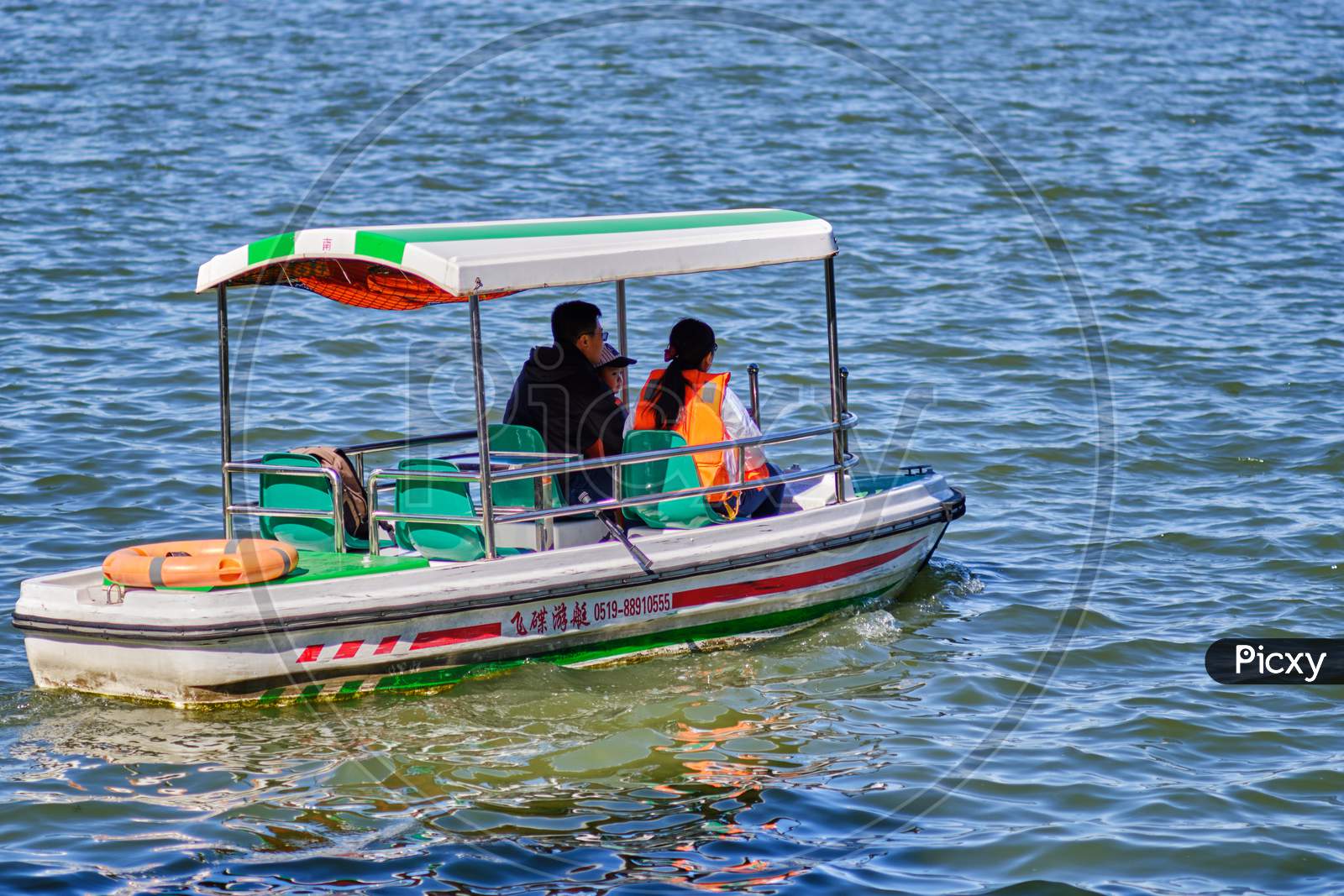 Family Enjoying Pedal Boat Ride In Beihai Lake, Beihai Park, Beijing