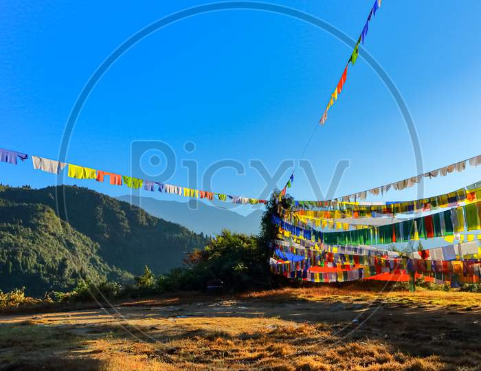Colorful Tibetan prayer flags against early morning sun
