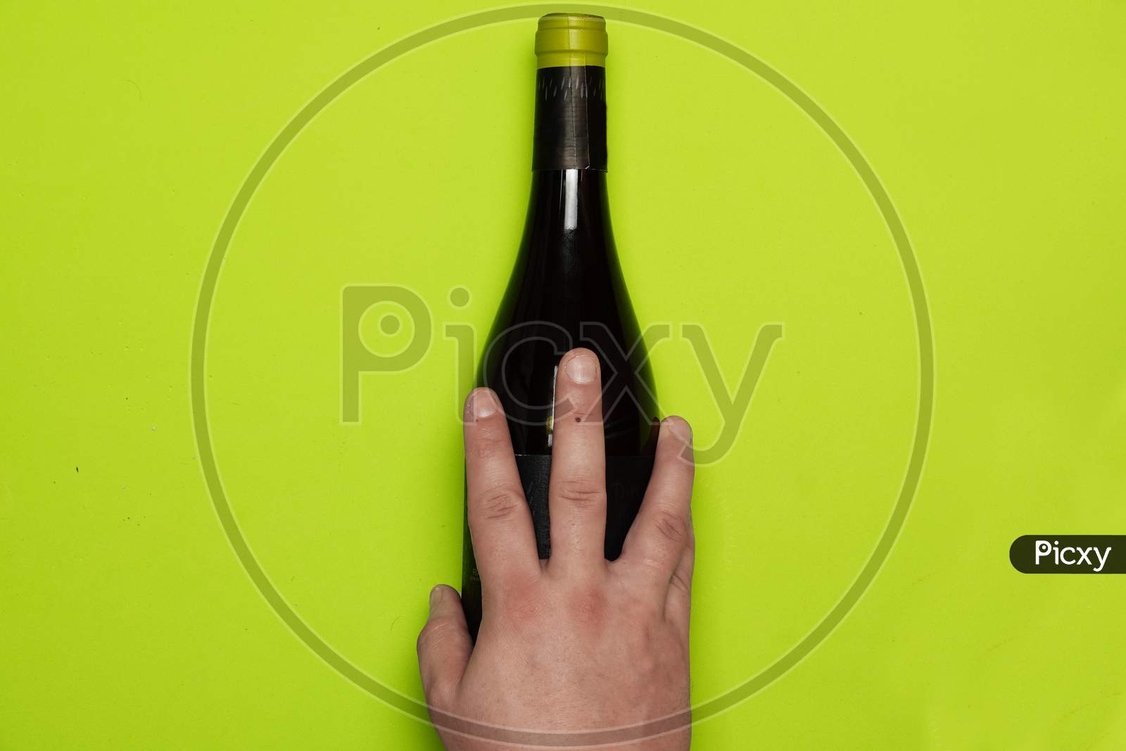 Top View Of Man'S Hand Over Wine Bottle. Flat Lay