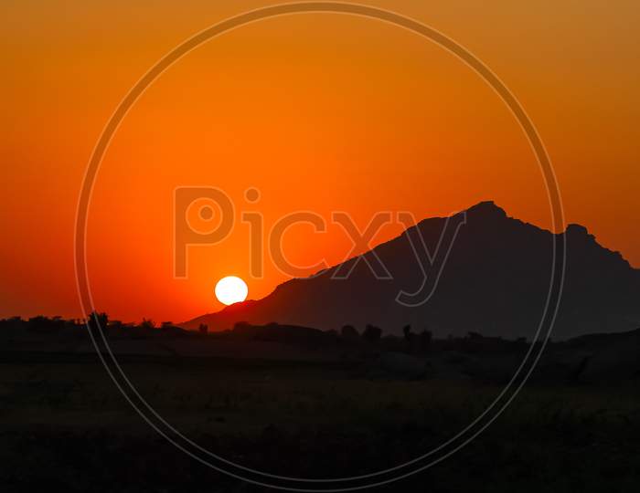 An image with dynamic range of Sun rise from behind the Aravalli mountain ranges
