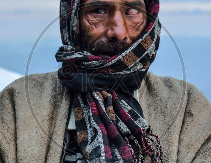 Portrait of A man form te mountains blind in one of his eyes