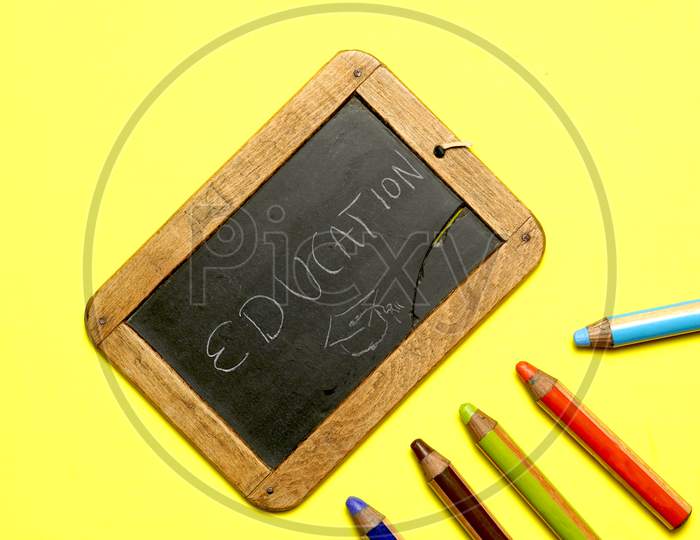 Blackboard With The Word Education Written With Colorful Paints. Flat Lay
