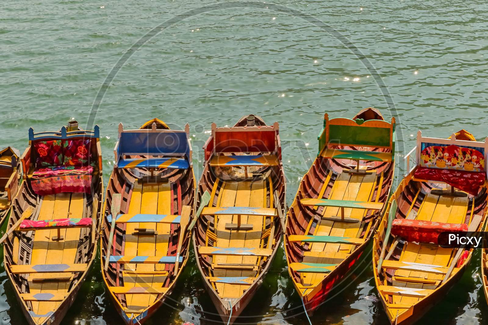 Boats floating on water in a lake in hill station Bhimtal in Nainital district