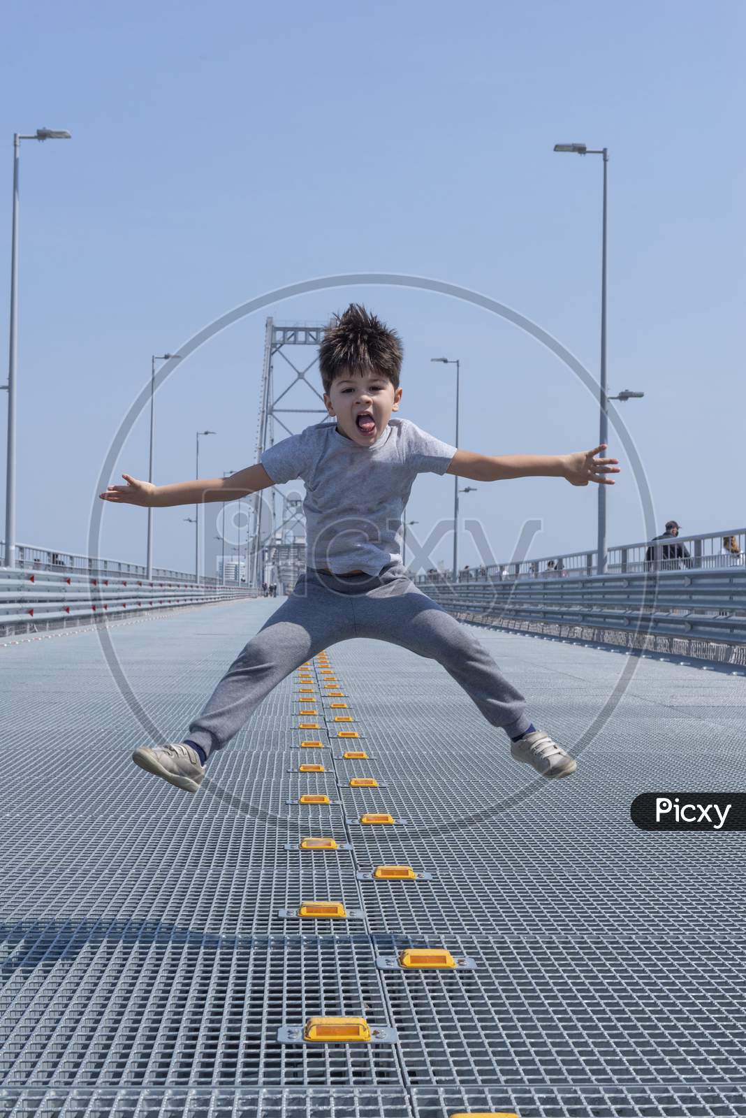 Isolated. Boy Jumping With Arms And Legs Open.