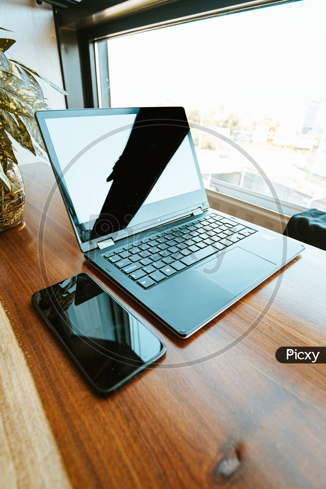 Work Space Composition With A Black Mobile Phone And A Black Laptop
