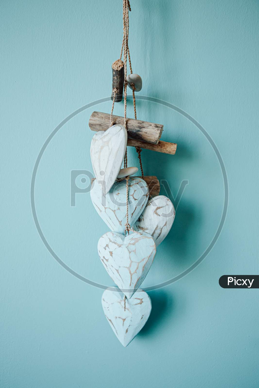 Beautiful Dream Catcher Made Of Wooden Hearts Over A Blue Background