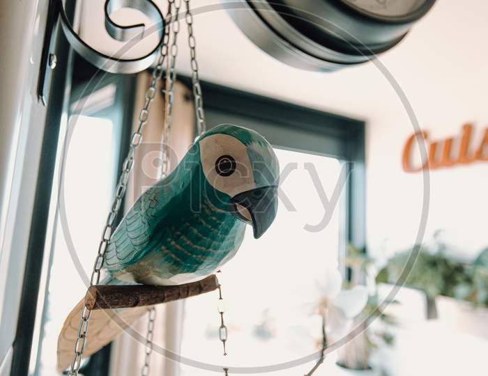 Ba Beautiful Wooden Made Parrot Near A Clock In The Kitchen