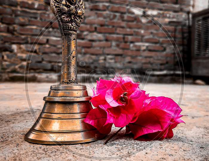 A worship bell with a pink flower