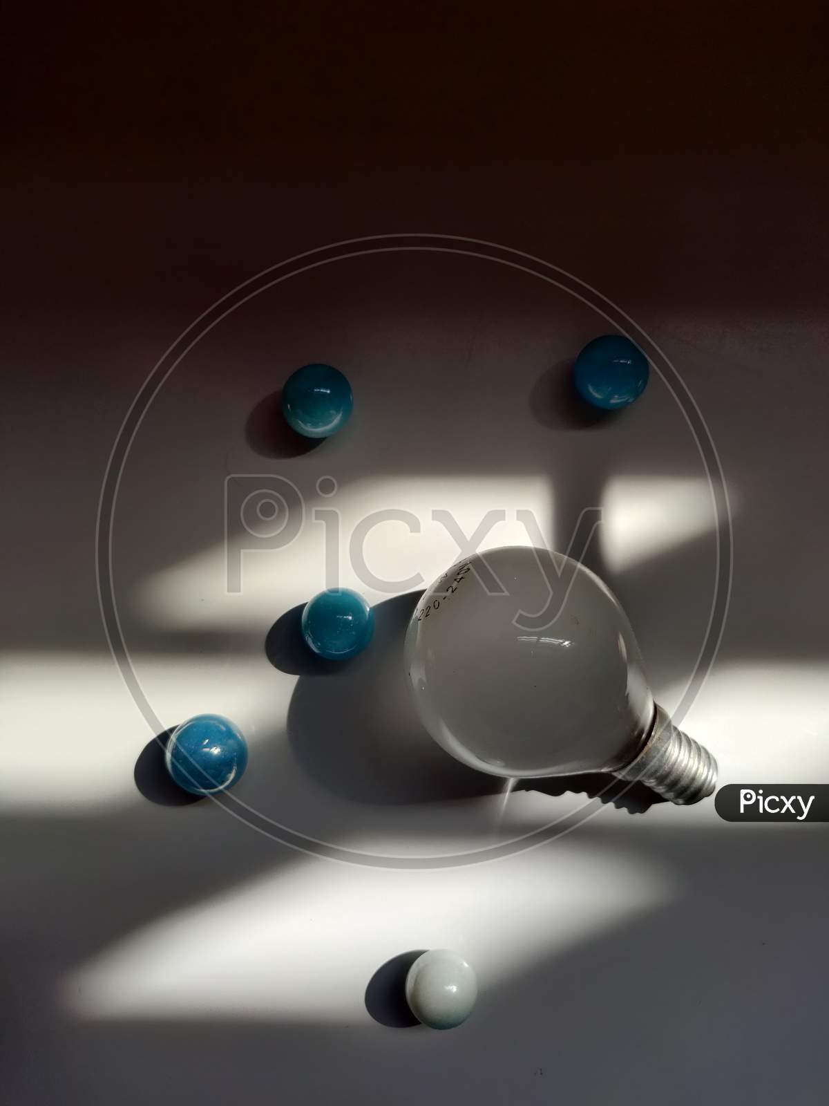 Bulb and marbles with sunlight