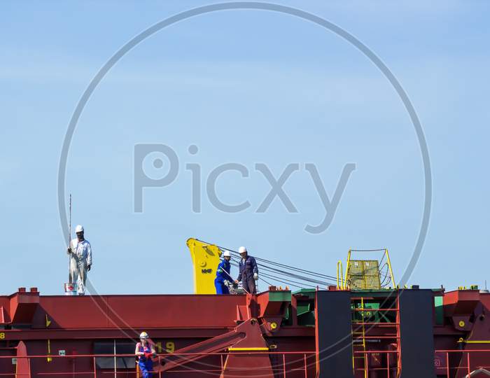 Gdansk, North Poland - August 14, 2020: Bunch Of Industrial Worker In Uniform Working In A Shipyard Next To Motlawa River During Corona Pandemic