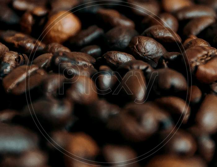 Super Close Up Of Some Toasted Coffee Grains On Dark Brown Tones
