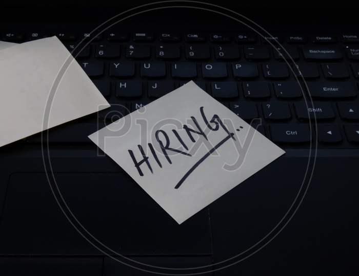 Hiring Advertisement Concept Written On Sticky Notes On Laptop.