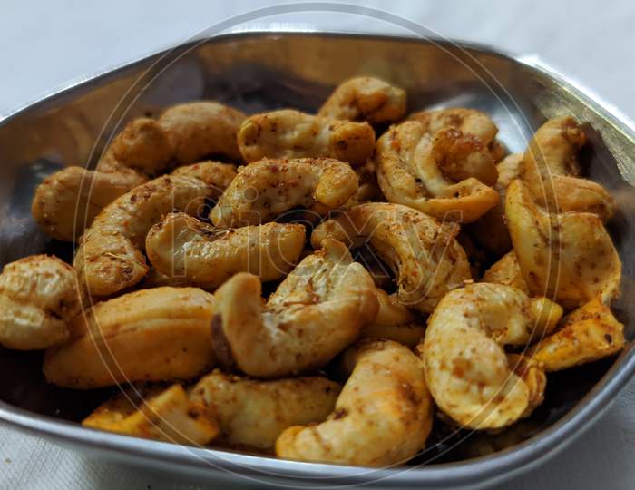 A photograph of roasted cashew , Masala Kaju.