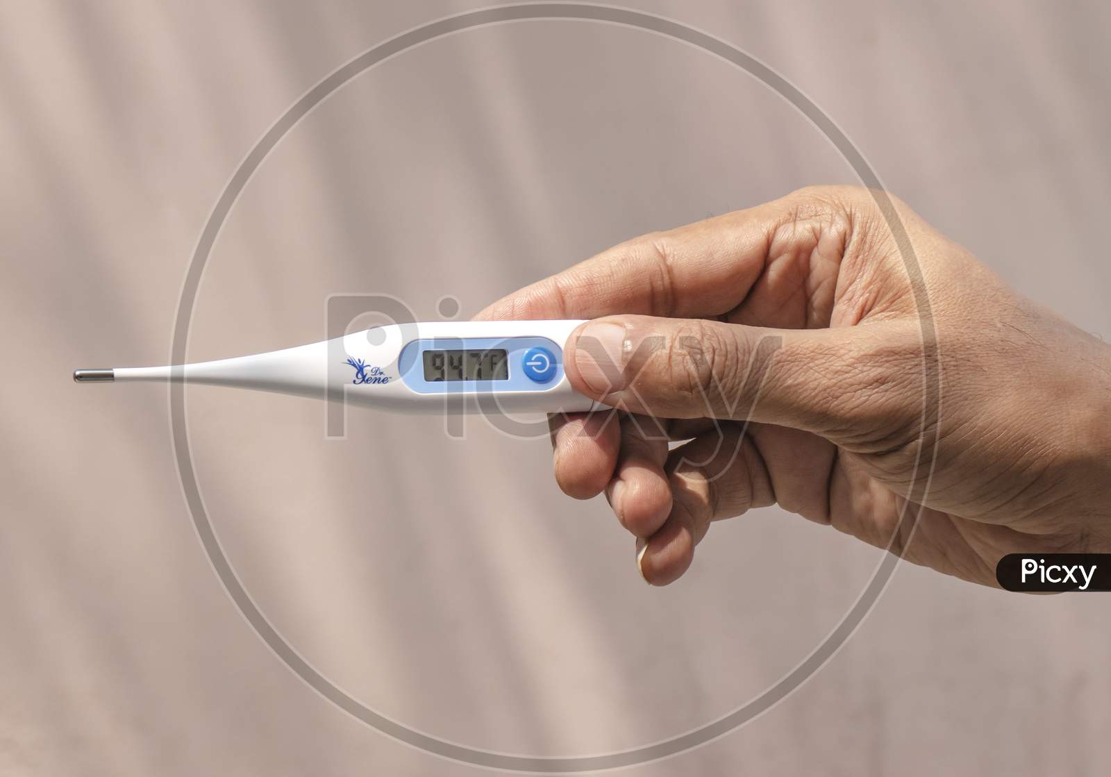 Man Holding Thermometer In Hand.