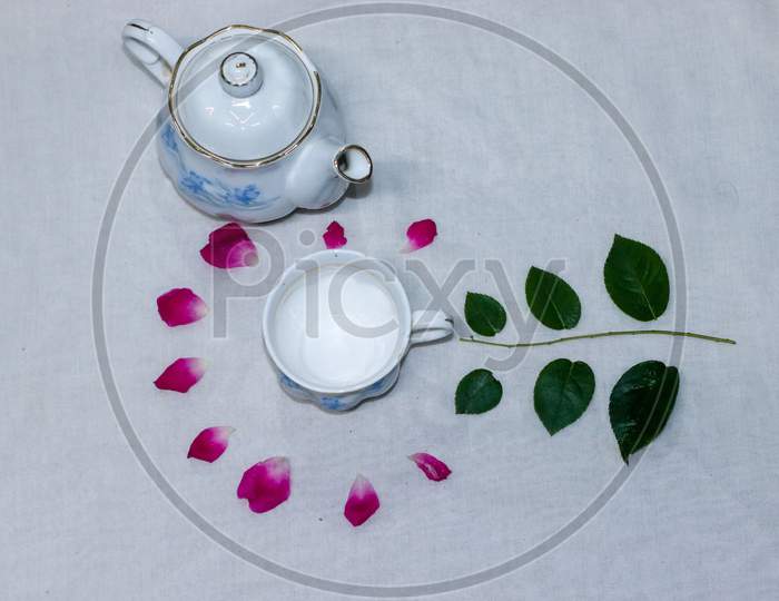 Empty Tea And Saucer With Rose Petals