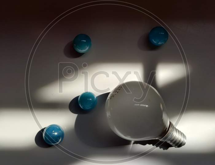Bulb and marbles with sunlight
