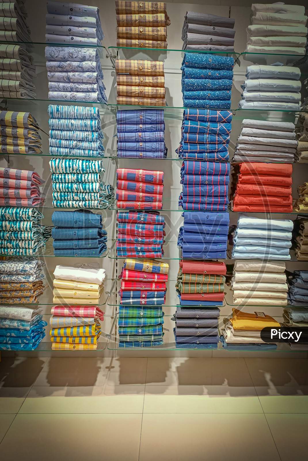 A Dramatic view of Cotton Casual Shirts in different colors and designs displayed at a Fashion store in Mysuru of Karnataka state in India.