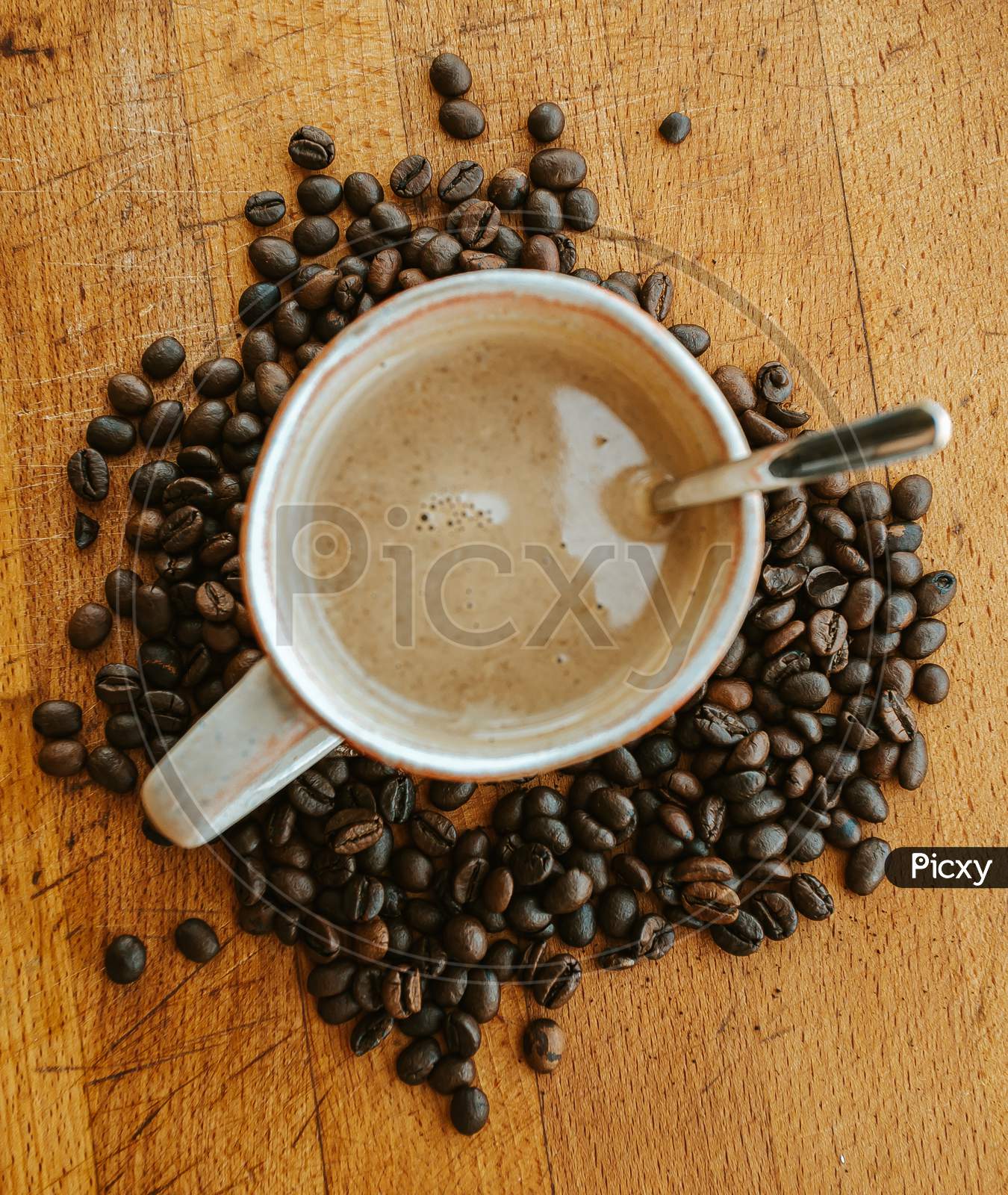 Super Close Up Flat Lay Of A Cup Of Coffee Surrounded By Coffee Grains