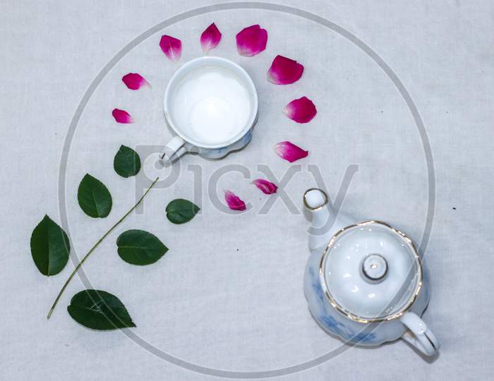 Empty Tea And Saucer With Rose Petals