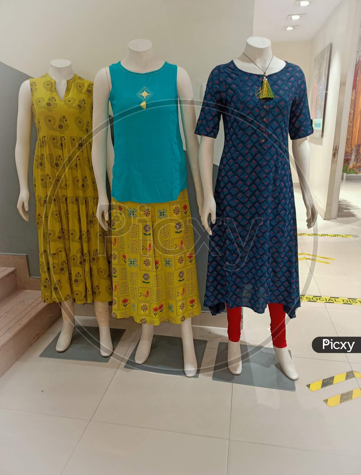 A Pretty picture of Mannequins dressed in traditional Indian Cotton Kurtis in in Multicolor and designs displayed at a Fashion store in Mysuru of Karnataka state in India.