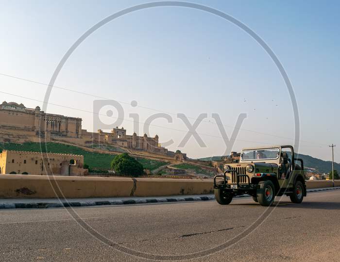Vehicles moving on Amer road in front of Amer or amber fort, jaipur