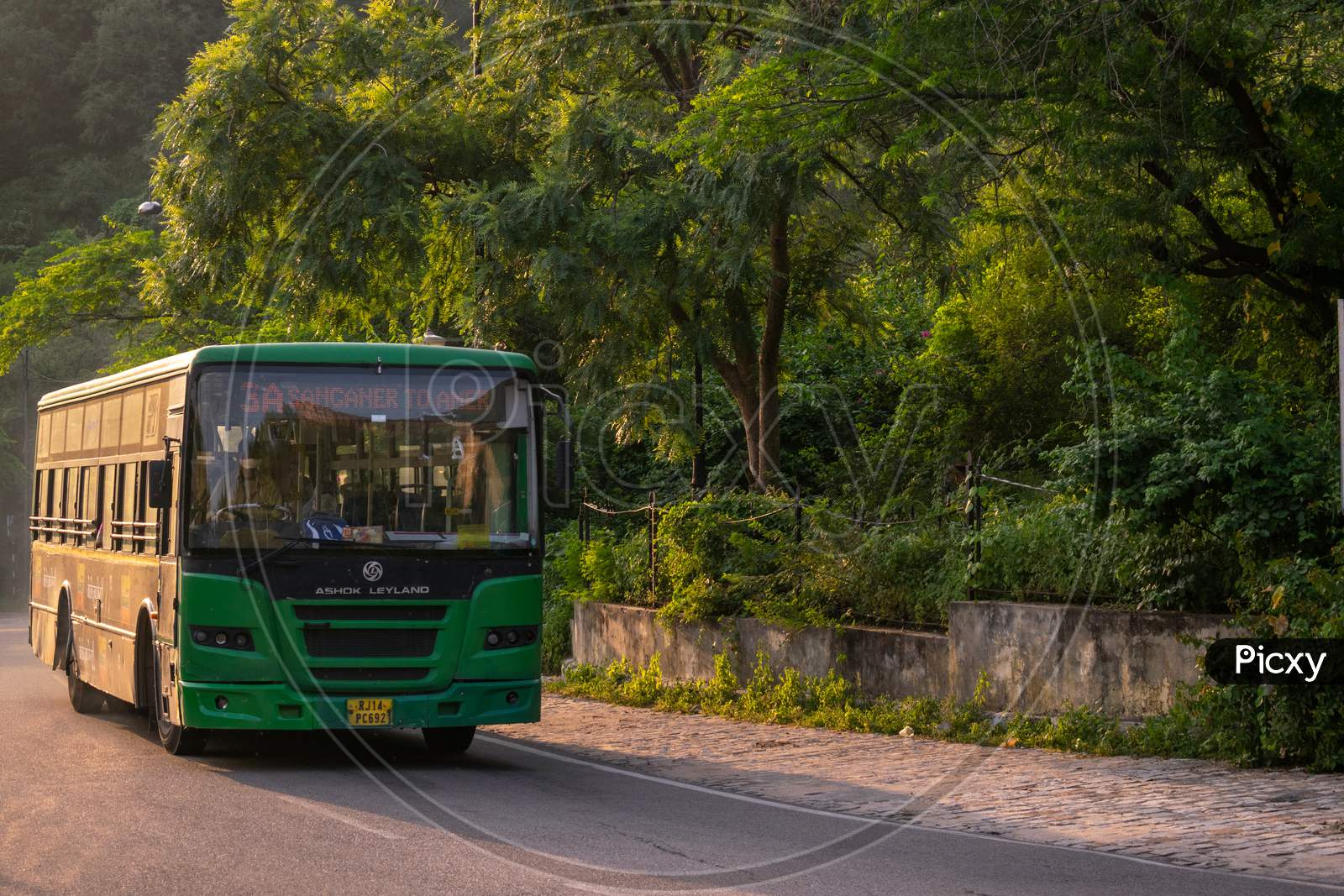 A Jaipur city bus or low floor bus moving on amer road