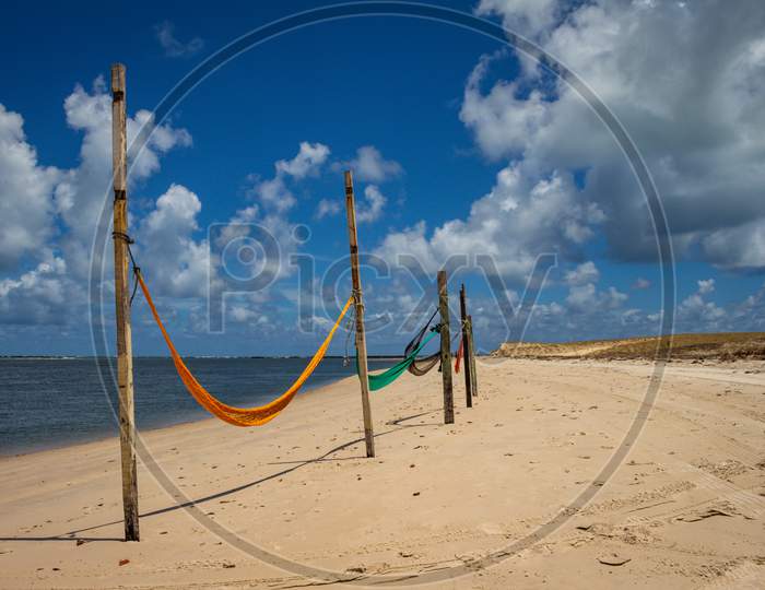 Hammocks To Rest On The Edge Of The Beach Tied To Stakes.