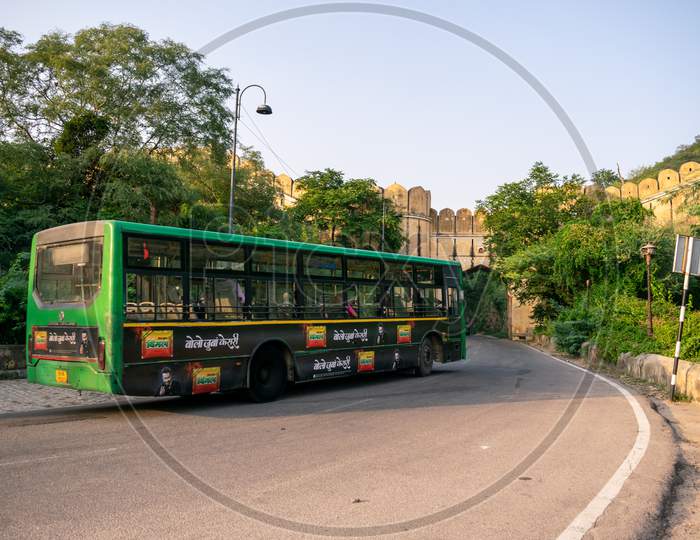 A Jaipur city bus or low floor bus moving on amer road
