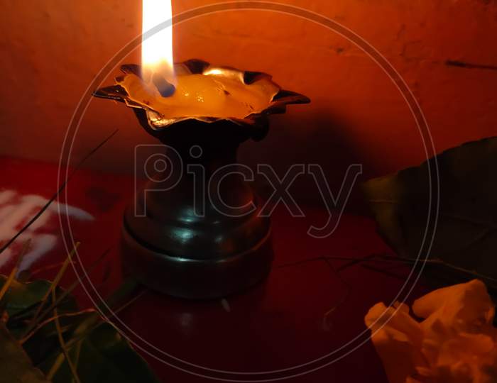 A Silver Diya Also Called As Traditional Oil Lamp With Flame.