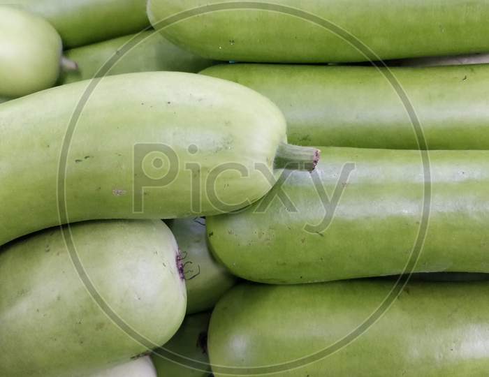 Closeup shot of a pile of zucchini in a market