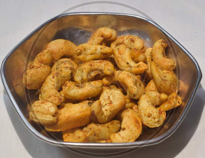 .Masala Kaju or spicy Cashew in a bowl. Popular festival snack from India/asia, also known as Chakna recipe