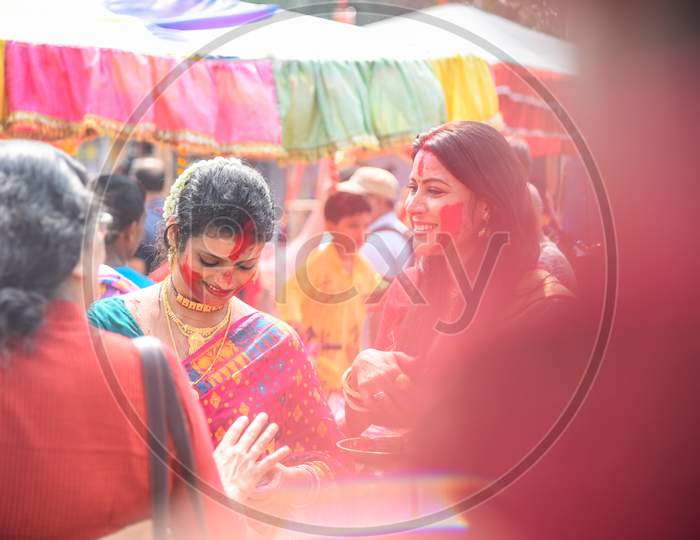 Kolkata, India – October 19 2018; Women participate in Sindur Khela at a puja pandal on the last day of Durga puja at Baghbazar Sarbojanin in Kolkata