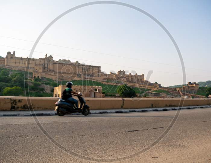 Vehicles moving on Amer road in front of Amer or amber fort, jaipur