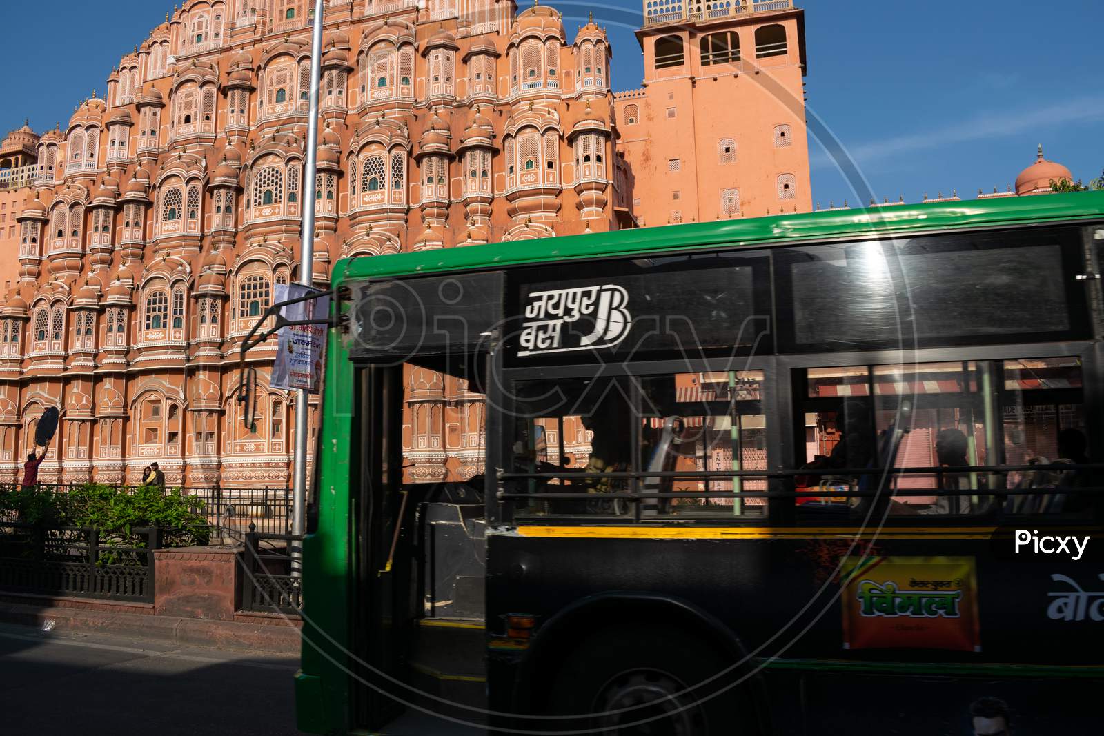 A Jaipur Bus or a low floor bus in front of Hawa Mahal, Jaipur