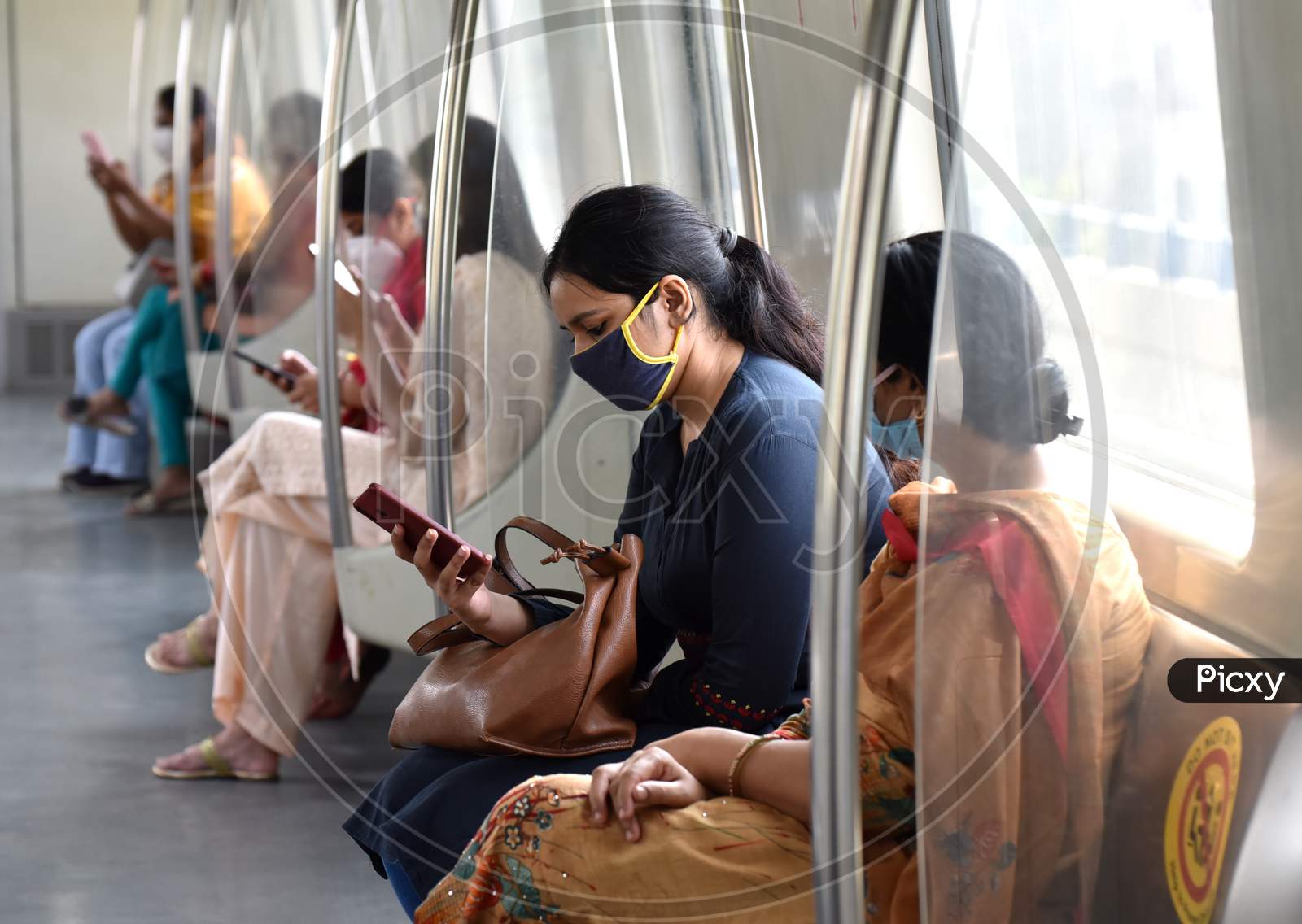 Passengers wearing face masks travel on a Delhi metro train, amidst the spread of coronavirus disease (COVID-19), in New Delhi, India, September 10, 2020.