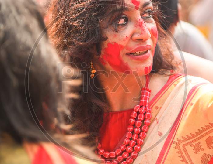 Kolkata, India – October 19 2018; Women participate in Sindur Khela at a puja pandal on the last day of Durga puja at Baghbazar Sarbojanin in Kolkata
