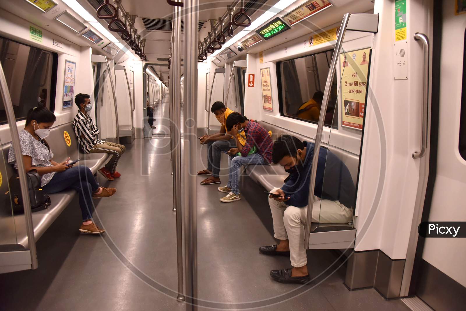 Passengers wearing face masks travel on a Delhi metro train, on the first day of the restart of their operations, amidst the spread of coronavirus disease (COVID-19), in New Delhi, India, September 7, 2020.