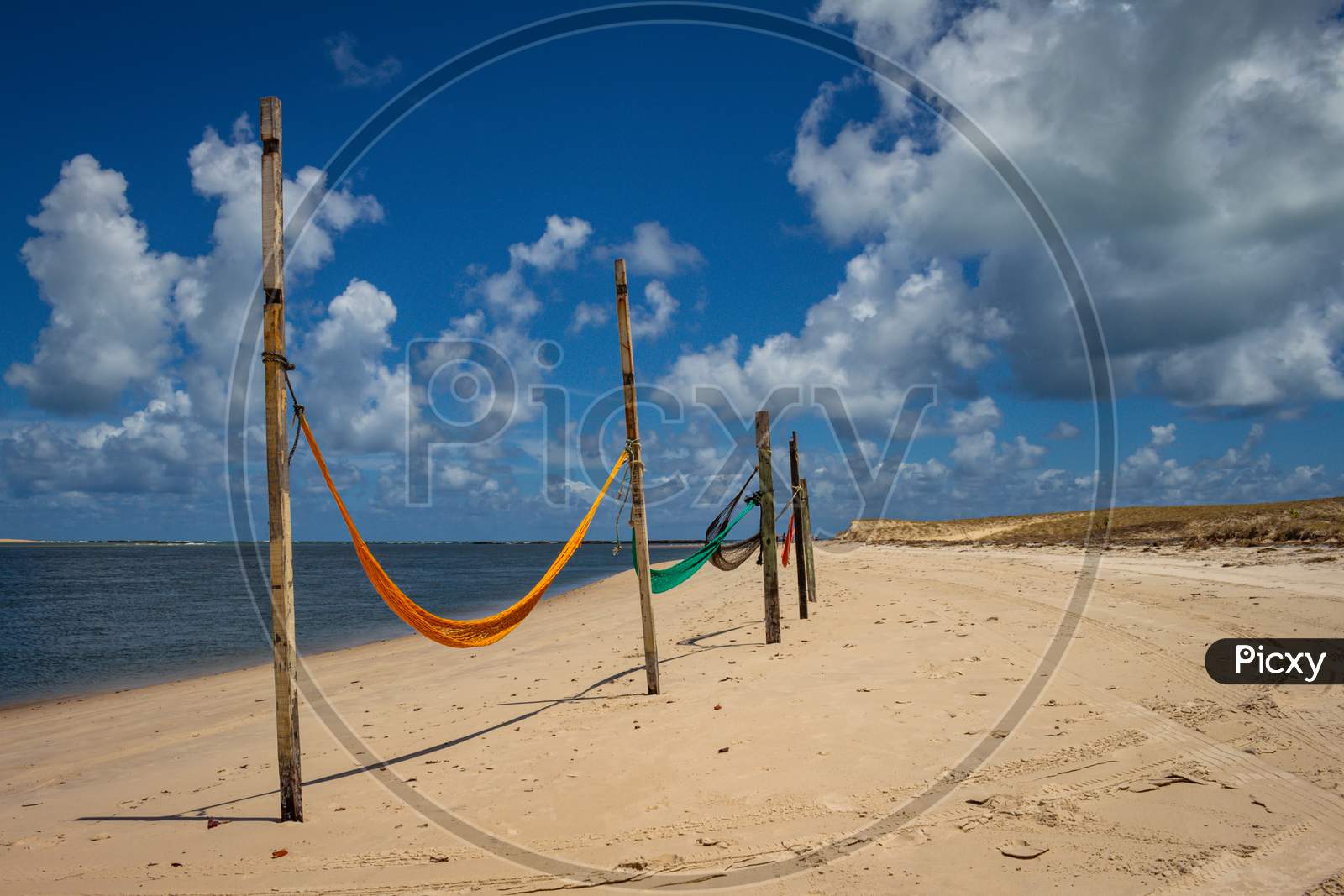 Hammocks To Rest On The Edge Of The Beach Tied To Stakes.