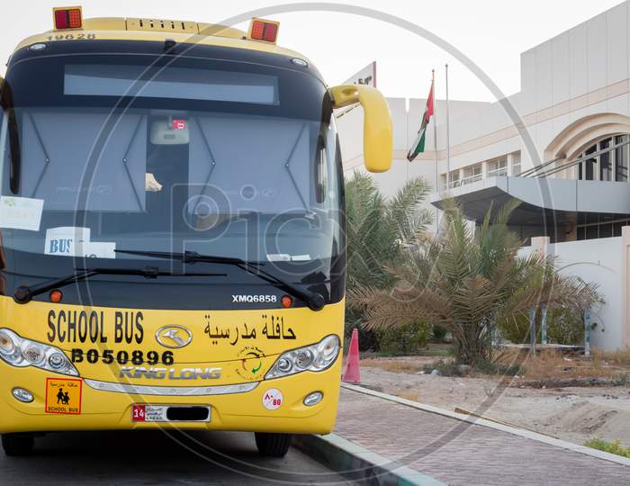 Yellow School Bus In Abu Dhabi, United Arab Emirates, Dubai, Emirates, Gulf, Middle East. Awareness Signs And Symbol Was Written In Arabic Language At School Bus.